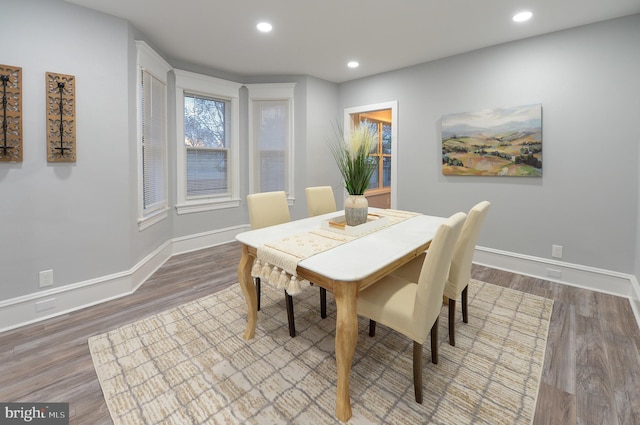 dining space featuring wood-type flooring