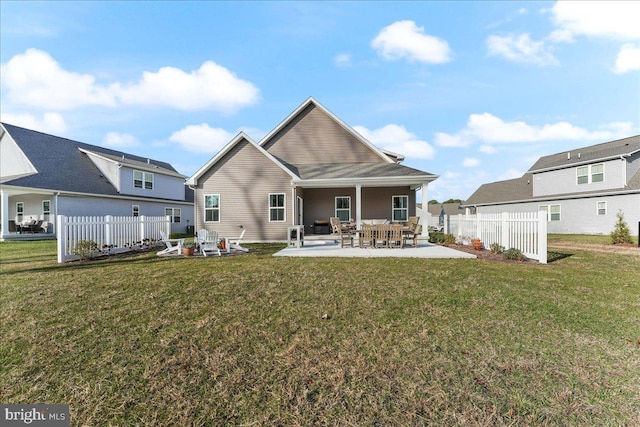 rear view of house with a patio area and a yard