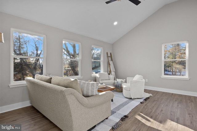 living room with ceiling fan, dark hardwood / wood-style flooring, and lofted ceiling