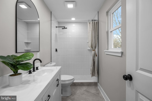 bathroom featuring tile patterned floors, vanity, toilet, and walk in shower