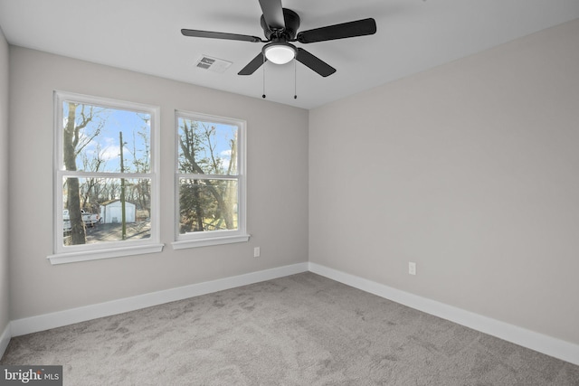 empty room featuring carpet floors and ceiling fan