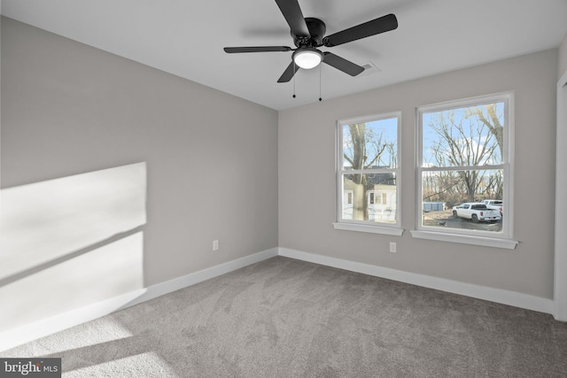 spare room with ceiling fan and carpet floors