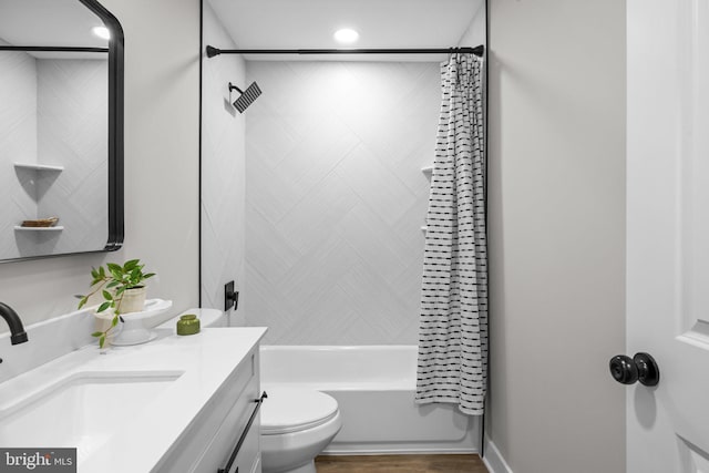 full bathroom featuring shower / tub combo with curtain, vanity, and toilet