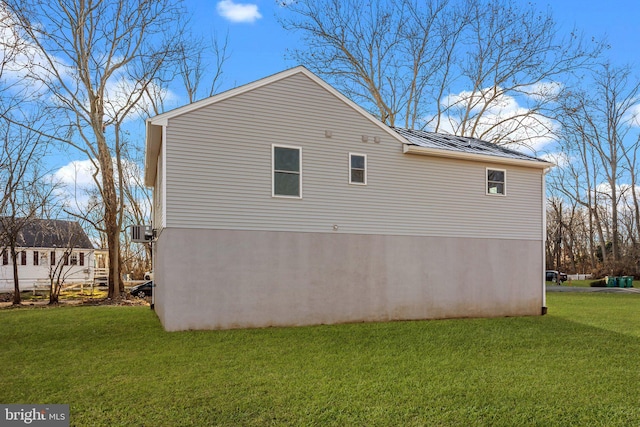 view of side of home featuring a lawn