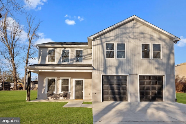 view of front of home featuring a front yard and a garage