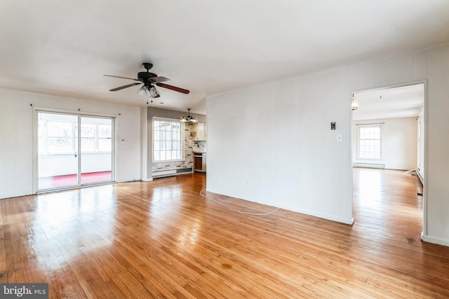 unfurnished living room featuring ceiling fan, light wood-type flooring, and baseboard heating