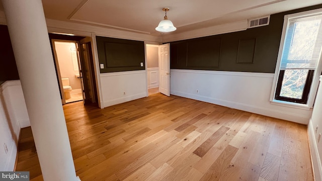 unfurnished bedroom with light hardwood / wood-style flooring and multiple windows