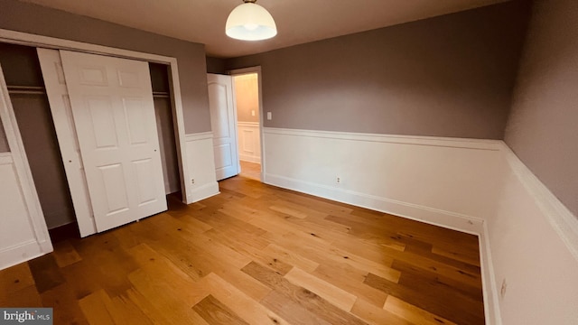 unfurnished bedroom featuring hardwood / wood-style flooring and a closet