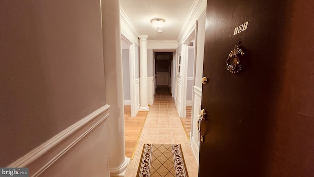 hallway featuring light tile patterned flooring and crown molding