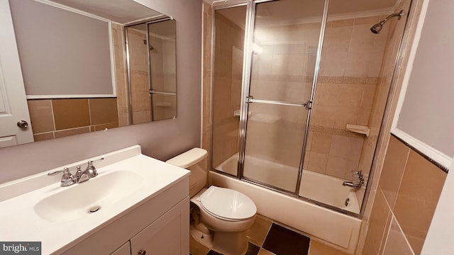 full bathroom with vanity, toilet, and enclosed tub / shower combo