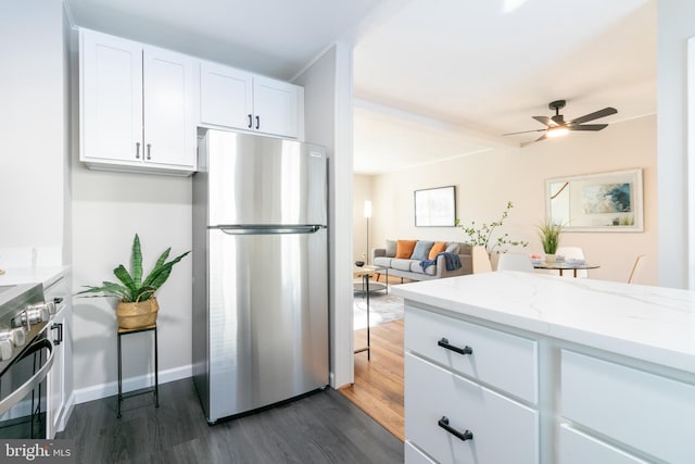 kitchen with stainless steel appliances, light stone countertops, ceiling fan, dark wood-type flooring, and white cabinets