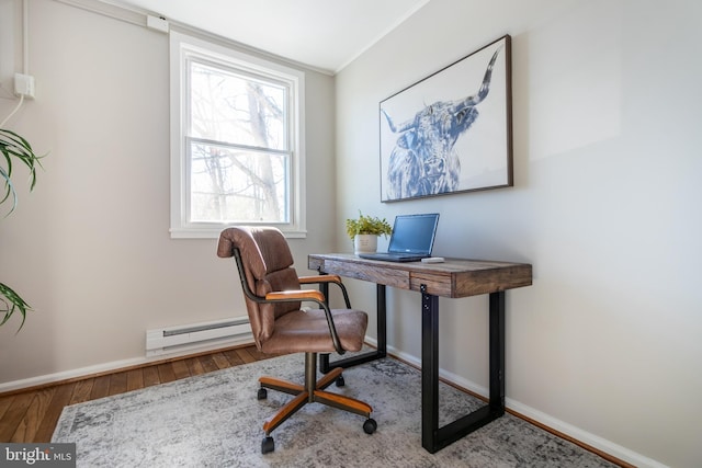 office space featuring crown molding, a baseboard radiator, plenty of natural light, and hardwood / wood-style flooring