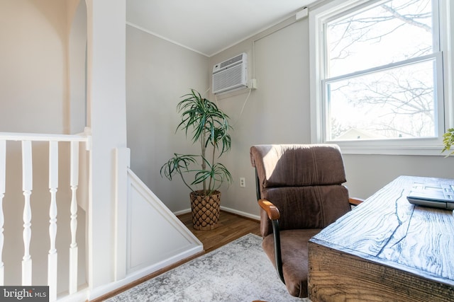 home office featuring an AC wall unit, ornamental molding, and hardwood / wood-style floors