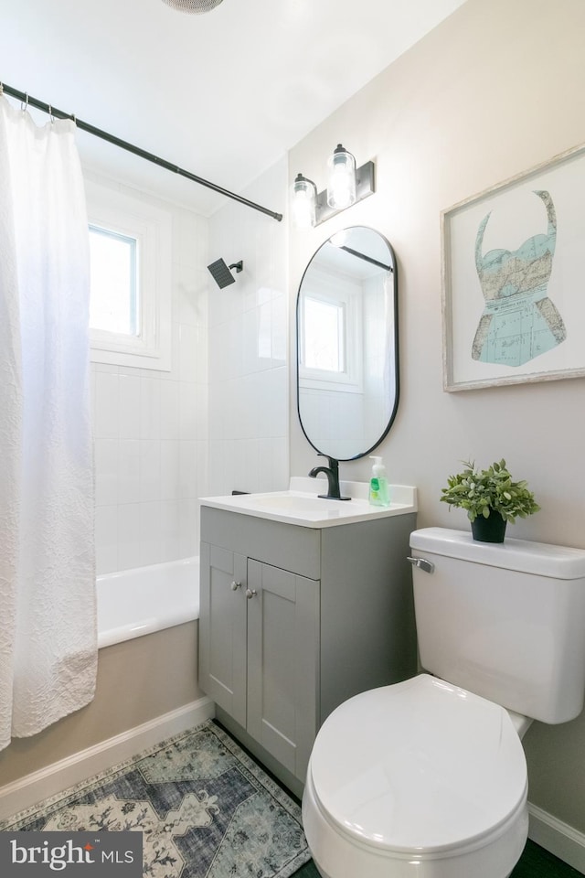 full bathroom featuring toilet, shower / bath combo with shower curtain, a wealth of natural light, and vanity