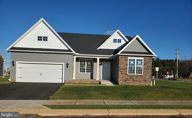 view of front of property featuring a front yard and a garage