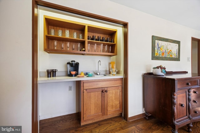 bar with dark hardwood / wood-style floors and sink