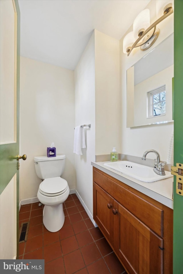 bathroom with tile patterned flooring, vanity, and toilet