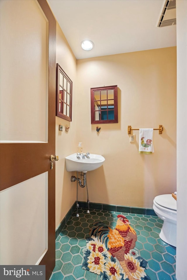 bathroom with tile patterned flooring and toilet