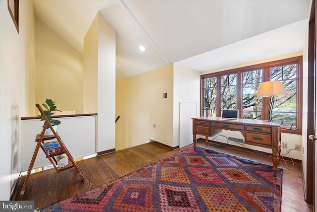 interior space with dark hardwood / wood-style flooring and vaulted ceiling