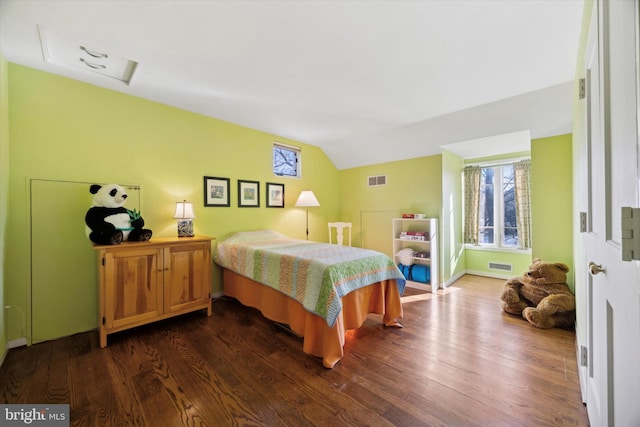 bedroom featuring vaulted ceiling and dark wood-type flooring