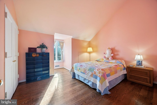 bedroom with dark hardwood / wood-style flooring and lofted ceiling