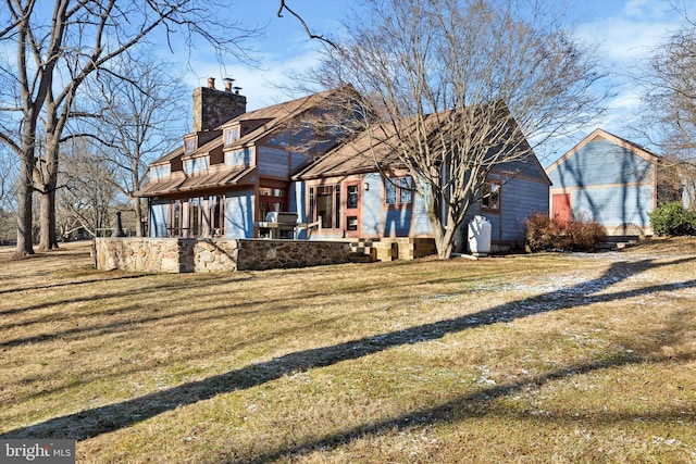 rear view of property with a lawn