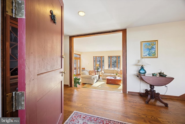 corridor with hardwood / wood-style flooring