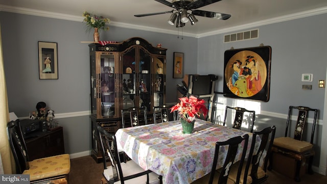 dining area with ceiling fan and ornamental molding