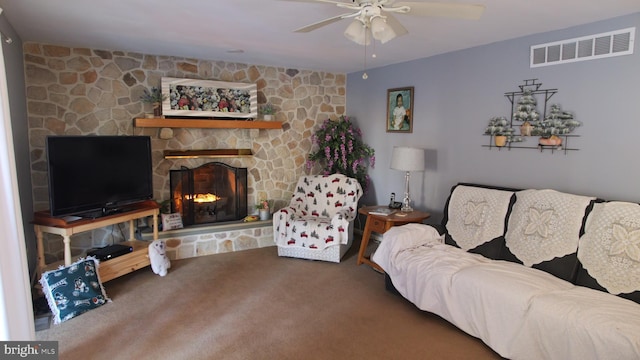 living room featuring a fireplace, carpet floors, and ceiling fan