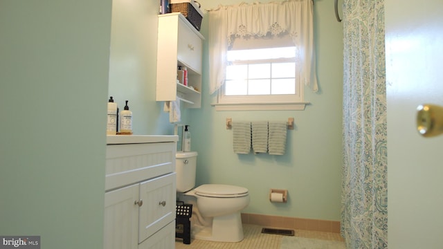 bathroom featuring tile patterned floors, vanity, and toilet