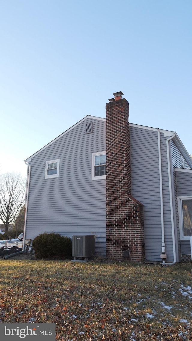 view of side of home featuring central AC