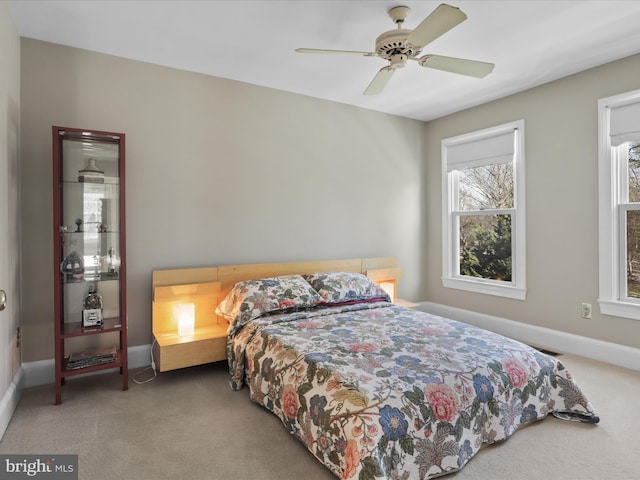 bedroom featuring a ceiling fan, carpet, and baseboards