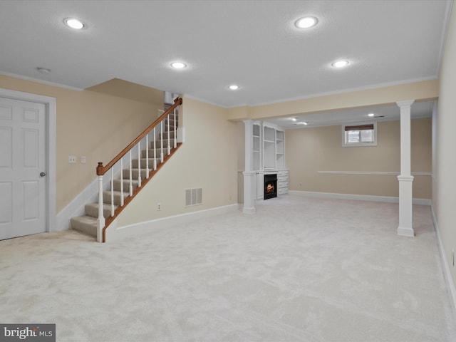 basement with recessed lighting, light carpet, visible vents, a lit fireplace, and stairway