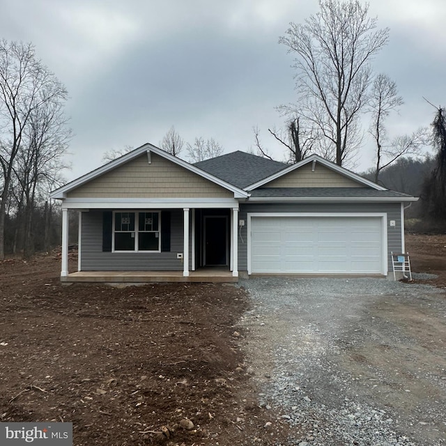 view of front of property featuring a porch and a garage