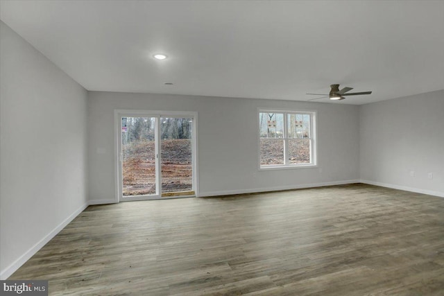 spare room featuring hardwood / wood-style floors and ceiling fan