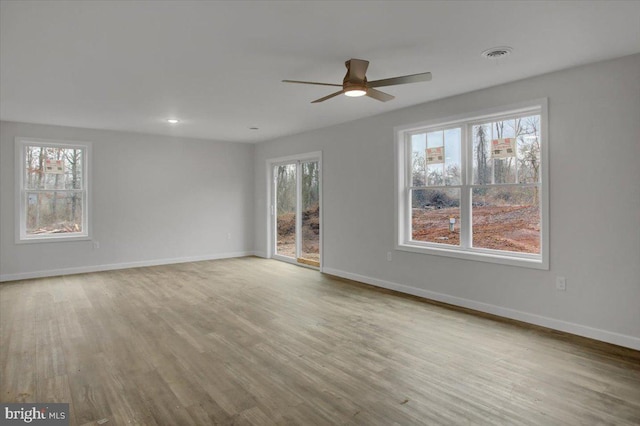 spare room featuring ceiling fan and light hardwood / wood-style floors