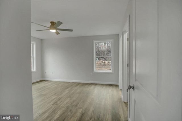 unfurnished room with ceiling fan and light wood-type flooring