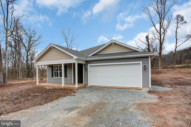 view of front of property featuring a garage and covered porch