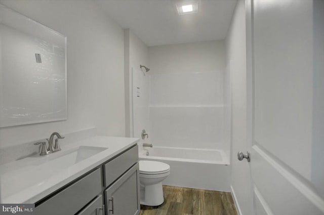 full bathroom featuring vanity, toilet, wood-type flooring, and shower / washtub combination