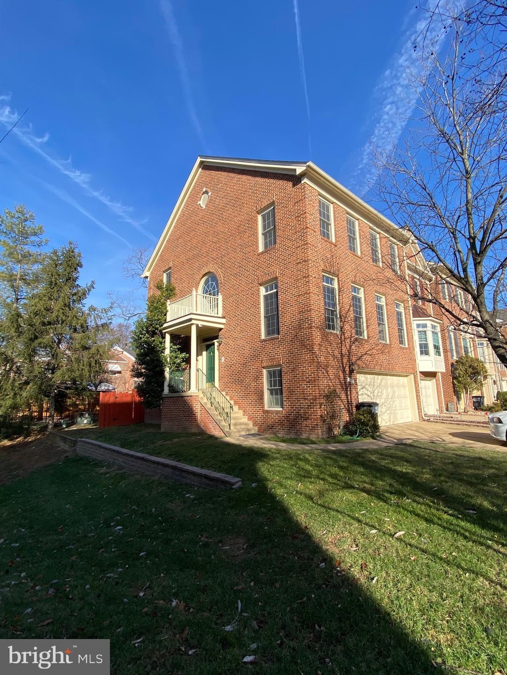 view of side of home featuring a yard and a garage