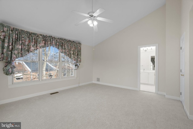 carpeted empty room featuring high vaulted ceiling and ceiling fan