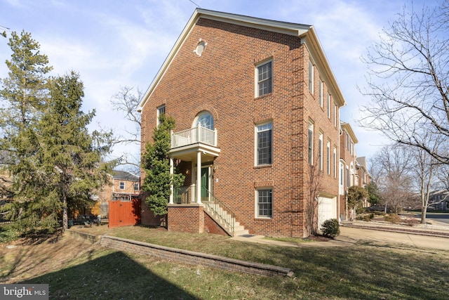 view of property exterior with a balcony, a garage, and a yard