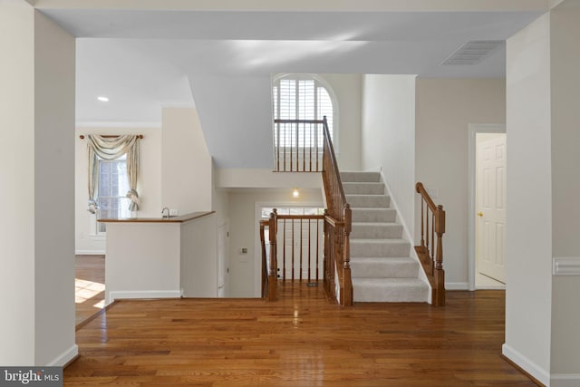 stairway with hardwood / wood-style flooring