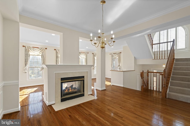 unfurnished living room with ornamental molding, dark hardwood / wood-style floors, and a multi sided fireplace