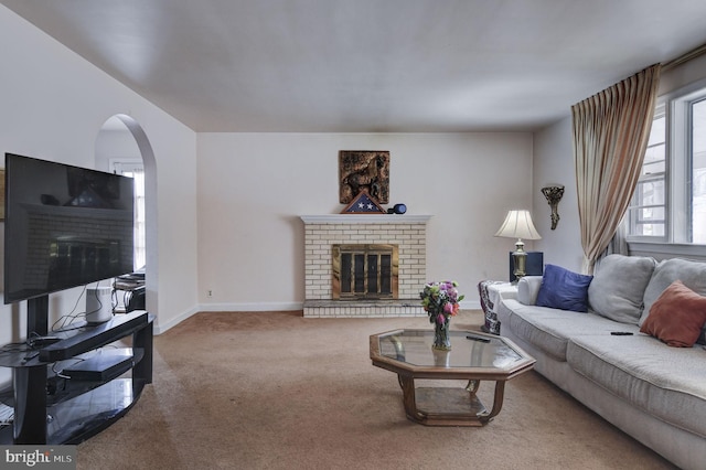 carpeted living room with a fireplace