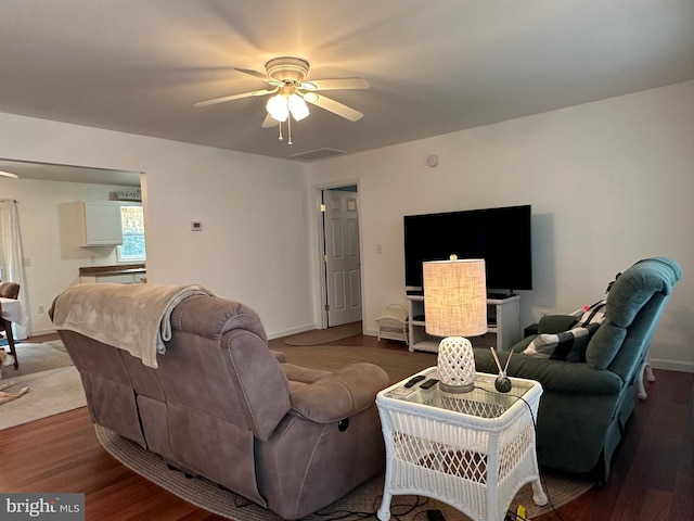 living room featuring ceiling fan and wood-type flooring