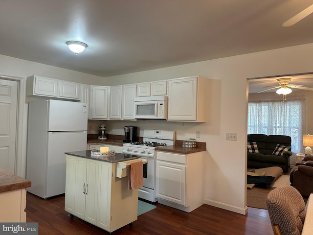 kitchen featuring white cabinetry, ceiling fan, dark hardwood / wood-style flooring, white appliances, and a kitchen island