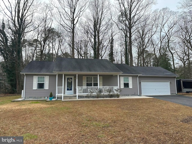 single story home featuring covered porch, a garage, and a front lawn