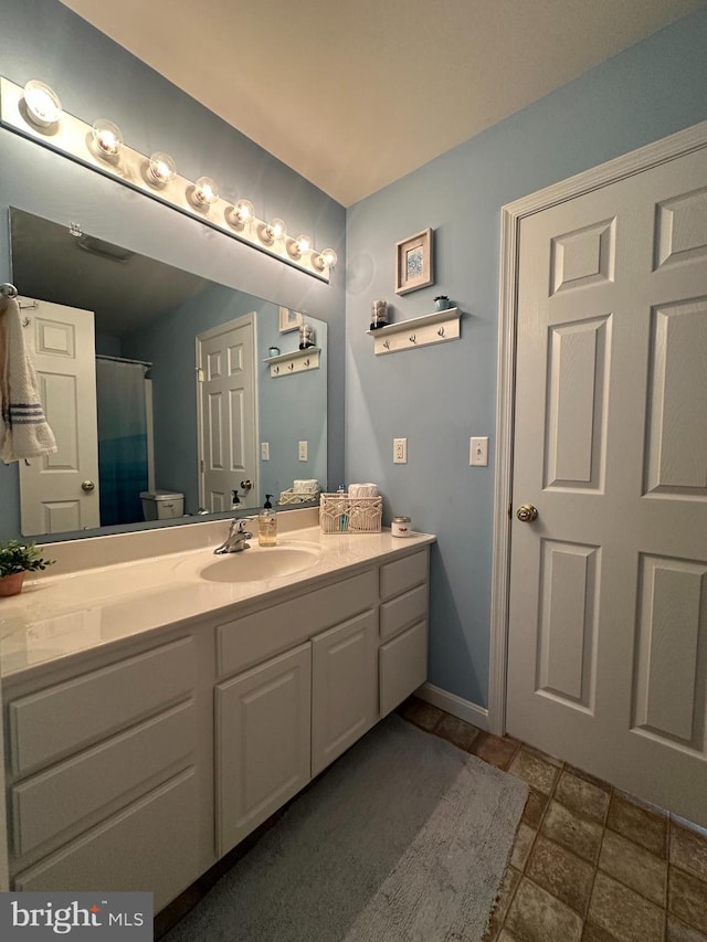 bathroom with curtained shower and vanity