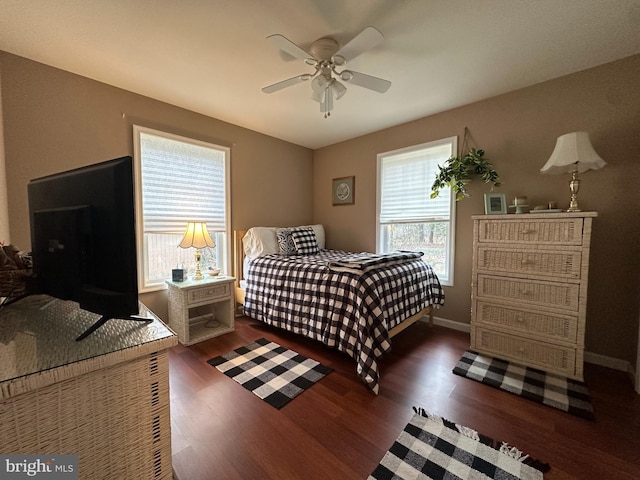 bedroom with ceiling fan and dark hardwood / wood-style flooring